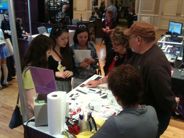 The booth of Metalliferous of NY, supplier of 'Mokume Gane' blanks,  is surrounded by eager young buyers