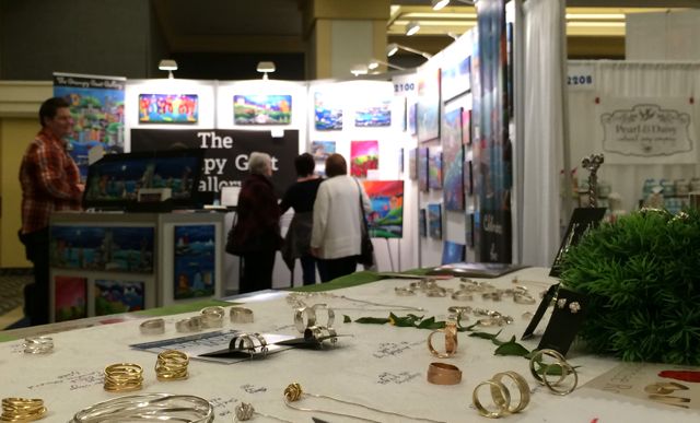 The Grumpy Goat booth with its colourful carved and painted pieces, across from my booth