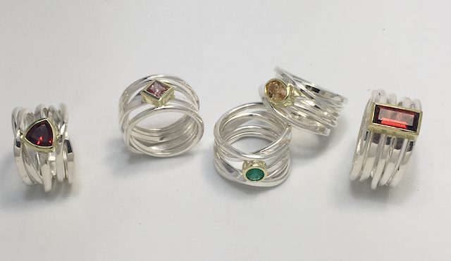 Some of the new Onefooter rings with gemstones I will be bringing with me to CircleCraft (left to right): trillion cut garnet, princess cut pink sapphire, natural emerald, oval imperial topaz, and garnet baguette