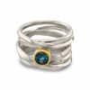 Onefooter ring, sterling silver, Size 7, with 5mm round blue zircon, set in 18k yellow gold bezel.