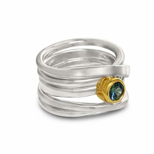 round Australian sapphire set in 18k yellow gold atop a sterling wrapring