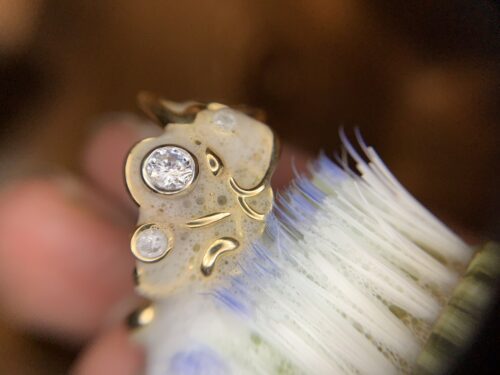 a soft toothbrush and mild dish soap clean a gold and diamond ring