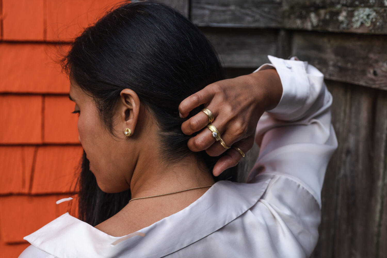 FLOW earrings and rings in sustainable and ethical 18k Fairmined ECO Gold on model by Dorothee Rosen
