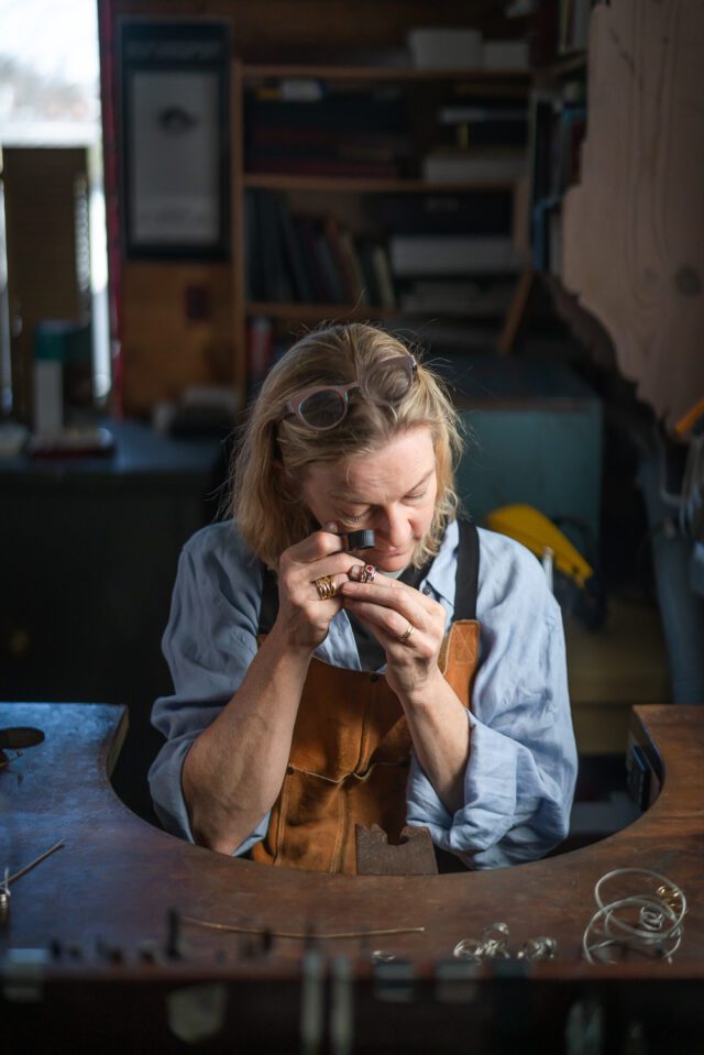 Dorothee Rosen studio inspecting gemstone