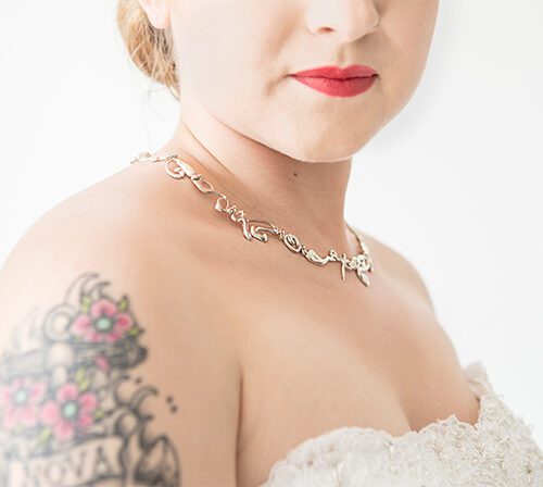 Script necklace on tattooed bride