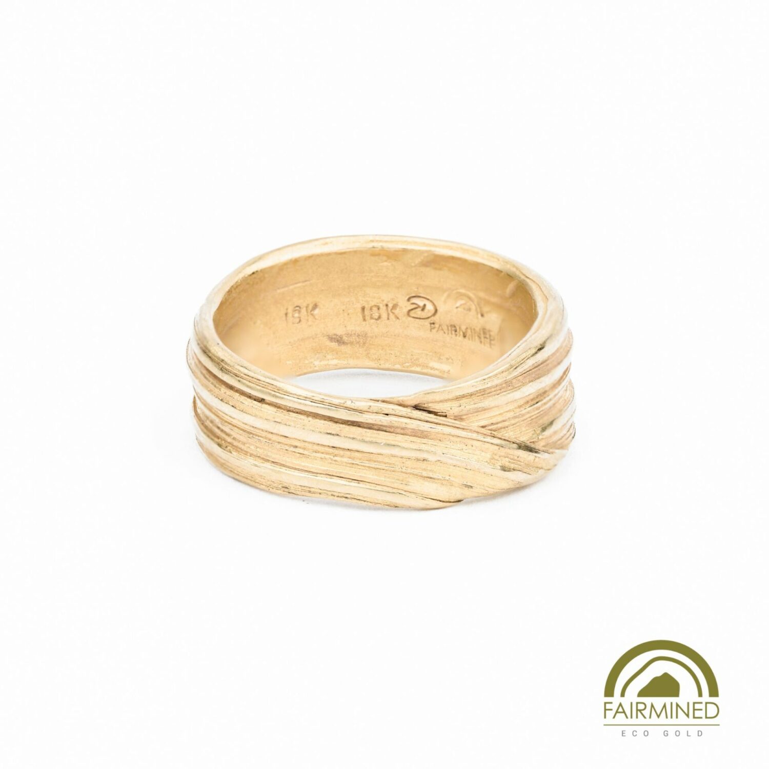wide yellow gold wedding band, richly textured, and appearing to fold